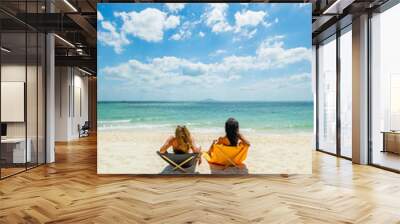 Woman enjoying her holidays on a transat at the tropical beach Wall mural