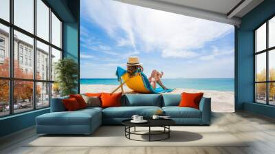 Woman enjoying her holidays on a transat at the tropical beach Wall mural