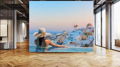 Woman enjoying relaxation in pool and looking at the view Wall mural