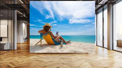 Young woman on the white sand beach Wall mural