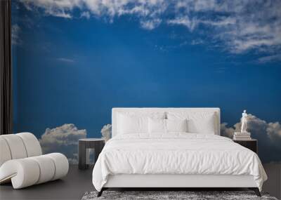 Blue sky punctuated with numerous fluffy and white clouds Wall mural