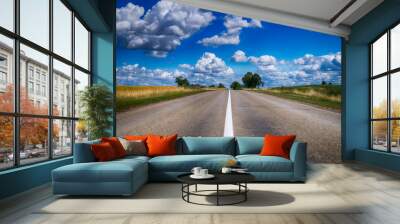 Low angle view of a tarred road receding Wall mural