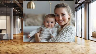 A cozy morning moment featuring a European-American actress enjoying a quiet time with her 10-month-old baby on the couch under soft industrial lighting Wall mural