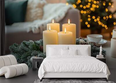 Christmas advent wreath with lit candles on a cozy table beside a decorated tree Wall mural