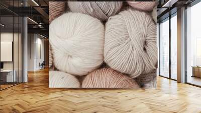 Craft knitting hobby background with yarn in natural colors. Recomforting hobby to reduce stress for cold fall and winter weather. Wall mural