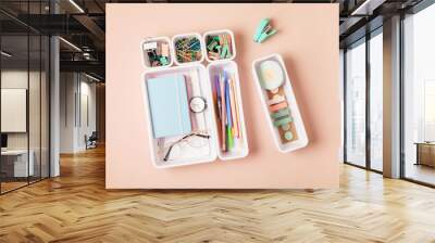 Desktop organization. Cleaning up messy stationary in plastic organizers for office and home desk Wall mural