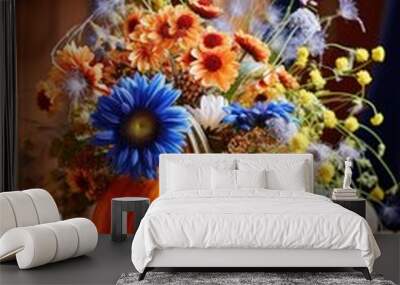 Handmade decoration for autumn holidays, thanksgiving, halloween with pumpkins and fall flowers in bright blue and orange colors Wall mural