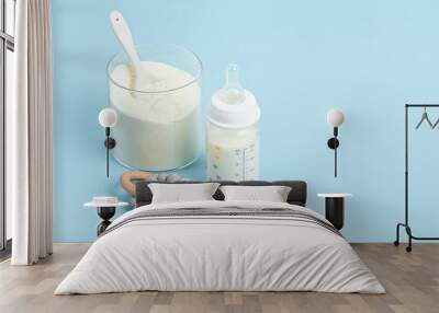 Preparation of formula for baby feeding. Baby health care, organic mixture of dry milk concept. Wall mural