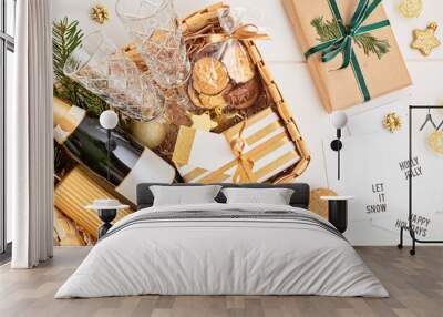 Refined Christmas gift basket for romantic holidays with bottle of champagne, wine glasses, cookies and candle. Corporate or personal present for family and friends. Wall mural