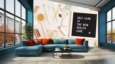 Self care is the new health care. Motivational quote on black letter board with variety of organic body and face care products. Natural homemade eco friendly beauty products Wall mural