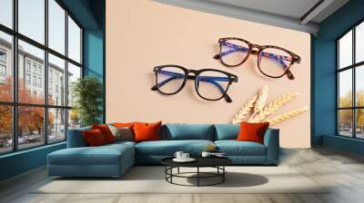 Stylish eyeglasses over pastel background. Optical store, glasses selection, eye test, vision examination at optician, fashion accessories concept. Top view, flat lay Wall mural