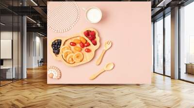 Top view of healthy breakfast for picky toddler with pancakes, tomatoes and berries. First safe plate and tableware for baby and toddler. Flat lay Wall mural