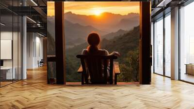 Woman sitting on the terrace with the view to the sunset in mountains. Meditation, mental health, holistic lifestyle, self care idea Wall mural