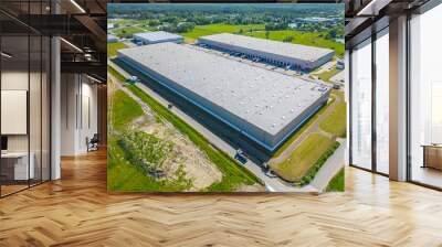 Aerial view of distribution center, drone photo of industrial logistics zone,new super modern logistics center full of modern technology and robotics,roof solar power plant for green energy production Wall mural