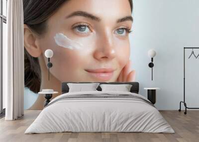 Skin care Cream smear. Beuaty close up portrait of young woman with a healthy glowing skin is applying a skincare product. Wall mural