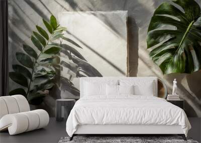 the mockup overlay weaves in shadows from an exotic plant, as natural light two vertical sheets of textured white paper resting on a soft gray table background. with leaves Wall mural