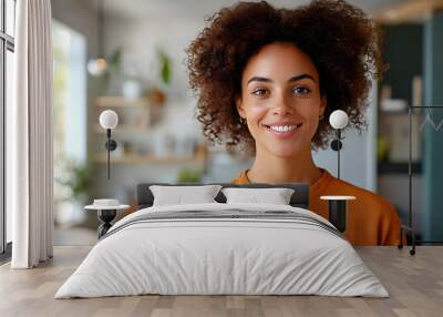 Smiling Woman with Curly Hair Looking at the Camera - Portrait of Happiness Wall mural