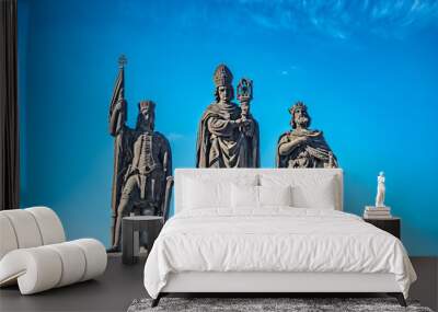 Statue of knights and priest at the Charles Bridge in Prague, Czech Republic, summer time, blue sky Wall mural