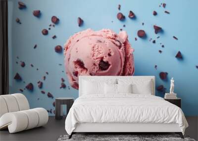 Top view of a single scoop of strawberry ice cream with chocolate chips on a blue background. Dessert and summer treat concept. Banner with copy space for ice cream shop advertising and menu. Wall mural