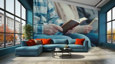 A cozy gathering of individuals holding books, showcasing a shared love for reading and literature.  Wall mural