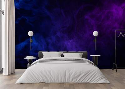 Colorful clouds of smoke and shiny dust on dark background Wall mural