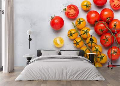 Small cherry tomatoes assortment, fresh red ripe on branch, red and yellow, whole and cut in half, on rustic table flat lay with copy space. Wall mural