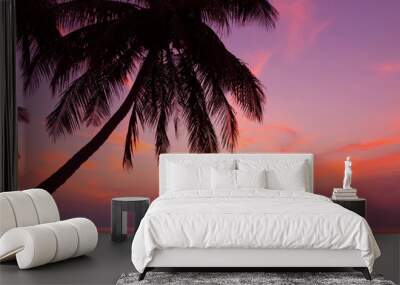 Tropical beach with coconut palm tree at sunset Wall mural