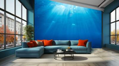 Underwater shot with sunrays and fishes in deep tropical sea Wall mural