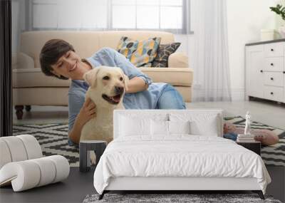 Adorable yellow labrador retriever with owner at home Wall mural