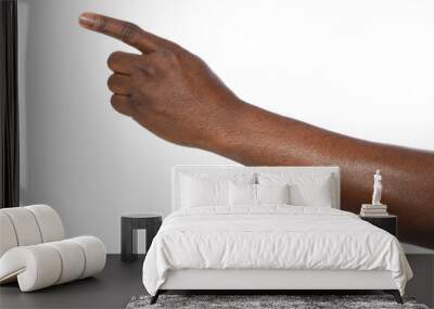 African-American man pointing at something on white background, closeup Wall mural