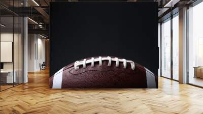 American football ball on black background, closeup. Space for text Wall mural