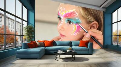 Artist painting face of little girl indoors Wall mural