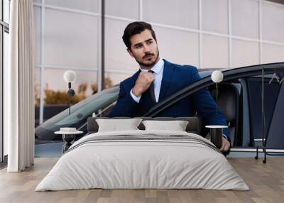 Attractive young man near luxury car outdoors Wall mural