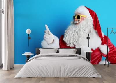 Authentic Santa Claus wearing sunglasses on color background Wall mural