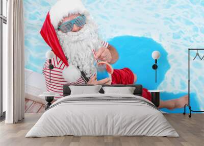 Authentic Santa Claus with cocktail near pool at resort Wall mural