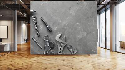 Auto mechanic's tools on grey stone table, flat lay. Space for text Wall mural