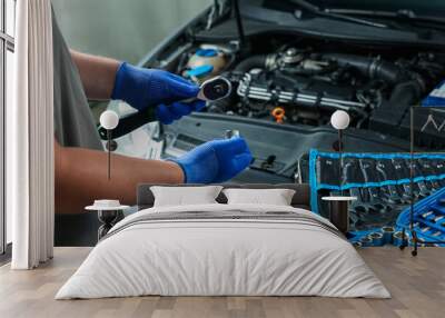 Auto mechanic with different tools at automobile repair shop, closeup Wall mural