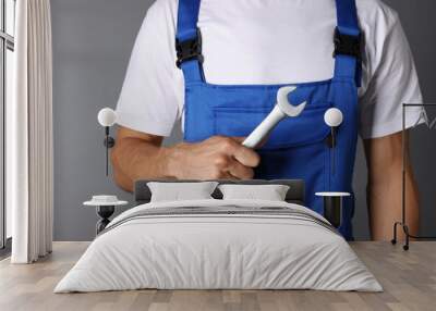 Auto mechanic with wrench on grey background, closeup Wall mural