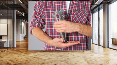 Auto mechanic with wrenches on grey background, closeup Wall mural