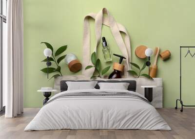 Bag with eco friendly products on green background, flat lay Wall mural