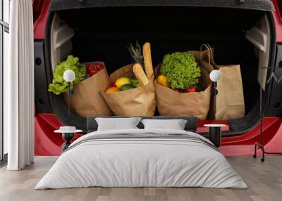 Bags full of groceries in car trunk, closeup view Wall mural