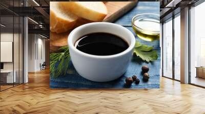 Balsamic vinegar, bread and other products on blue wooden table, closeup Wall mural