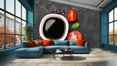 Balsamic vinegar, tomato and other products on black textured table, flat lay. Space for text Wall mural