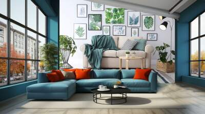 Beautiful artworks and comfortable couch in stylish room. Interior design Wall mural