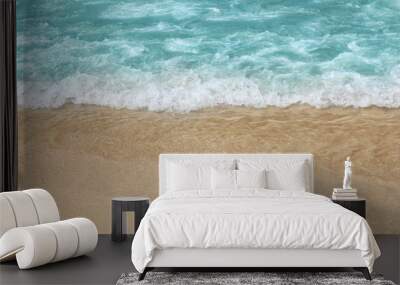 Beautiful blue wave with sea foam on sandy beach Wall mural