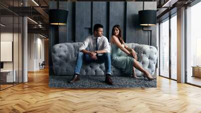 Beautiful couple in stylish living room. Luxury lifestyle Wall mural