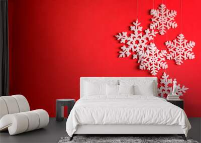 Beautiful decorative snowflakes hanging on red background, space for text Wall mural