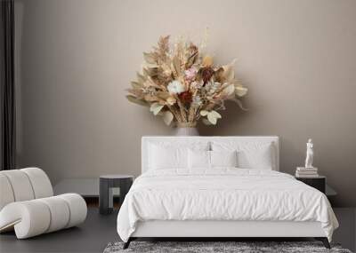 Beautiful dried flower bouquet in ceramic vase on white table near light grey wall Wall mural