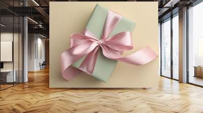 Beautiful gift box with pink bow on beige background, top view Wall mural