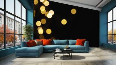 Beautiful golden lights on dark background. Bokeh effect Wall mural